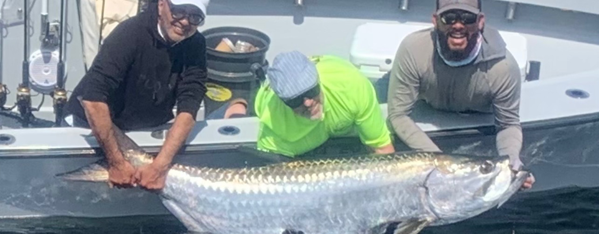 Two guests celebrate their catch during Miami Charter Fishing with Fetched Up Charters.