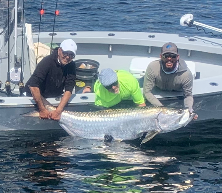 Two guests celebrate their catch during Miami Charter Fishing with Fetched Up Charters.