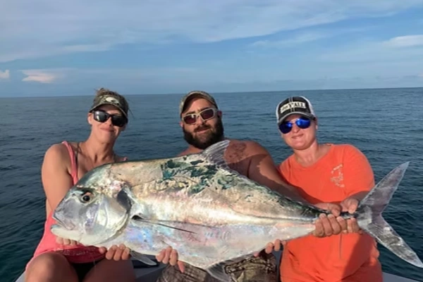 Two fishermen aboard Fetched Up Charters display a large catch from Sailfish Fishing Miami.